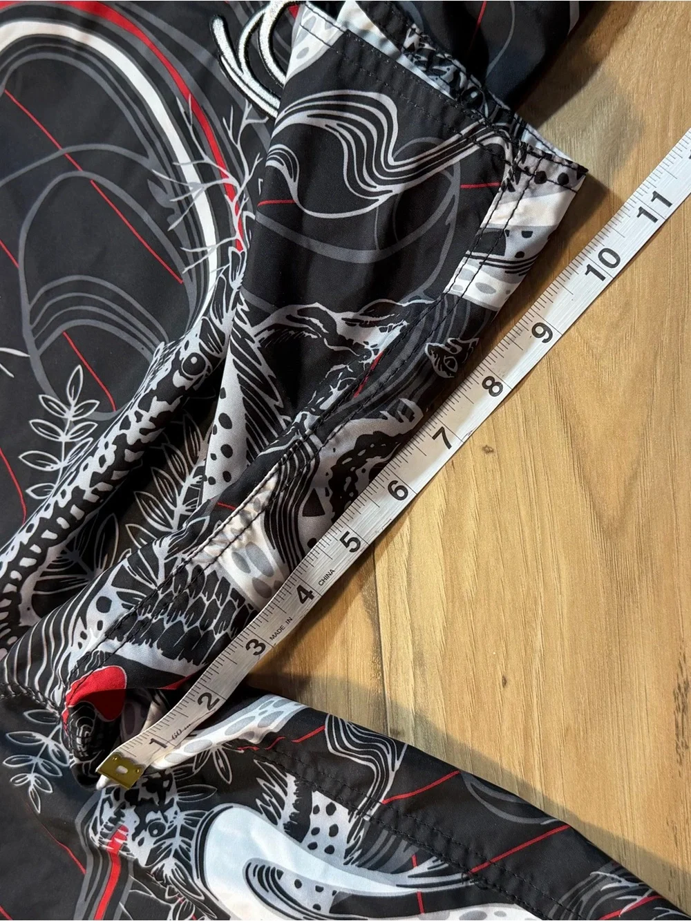 O'Neill black board shorts with white and red